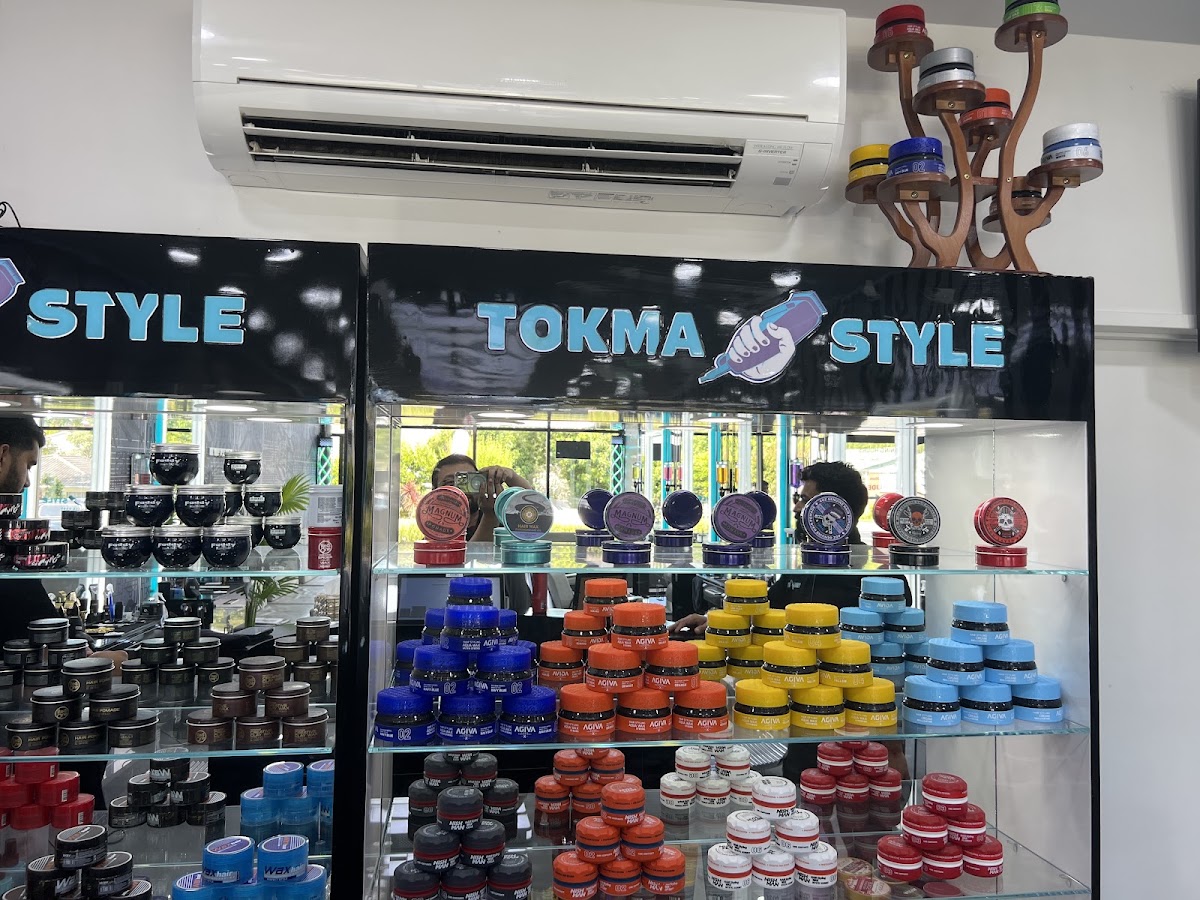 The Tokmastyle product wall stocked with waxes and pomades