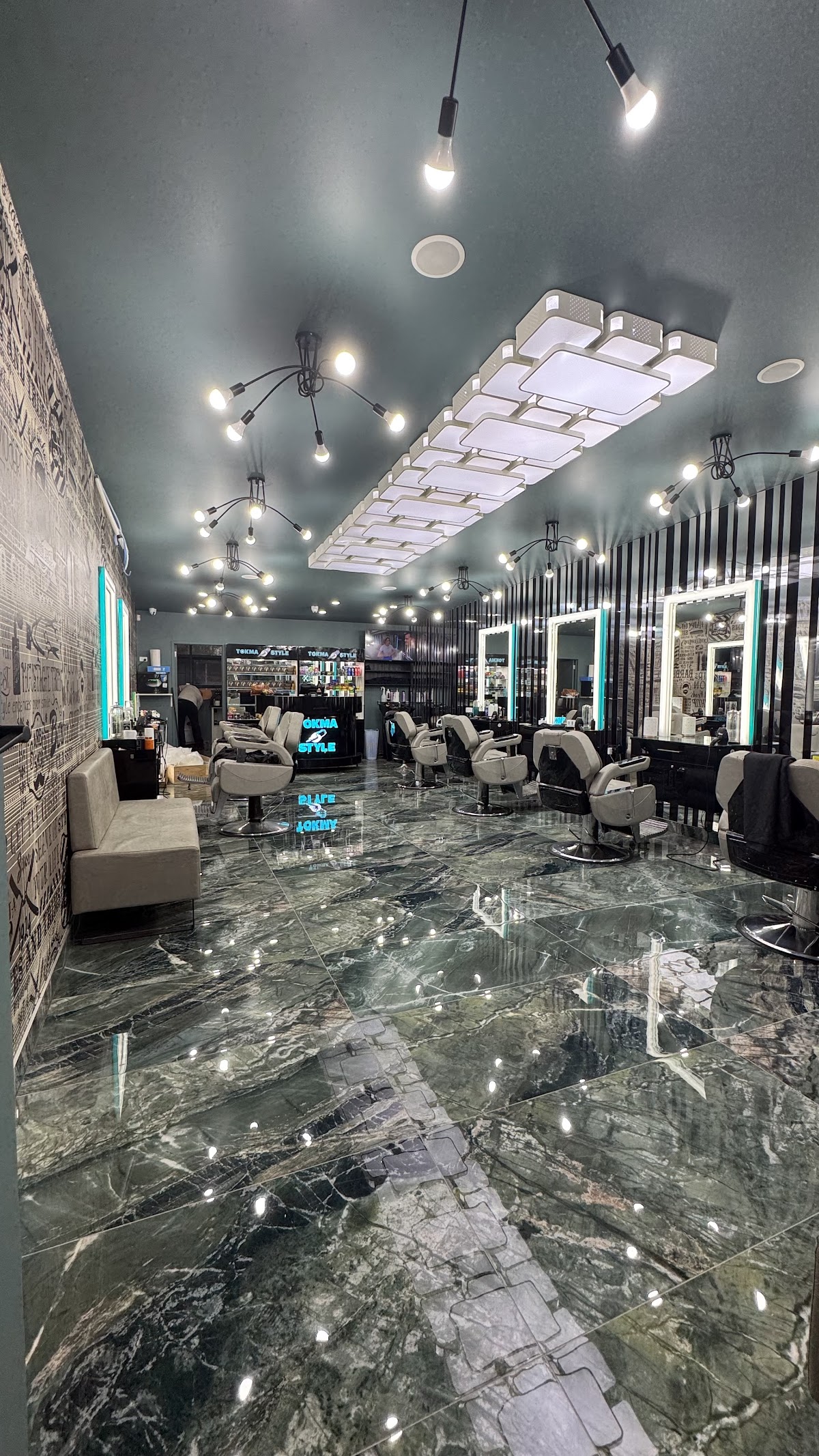 Inside Tokmastyle: marble floor, barber chairs and the illuminated counter